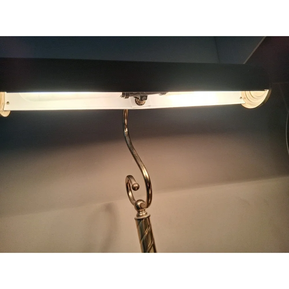 Vintage brass tone desk lamp with elegant scroll arm and classic piano light